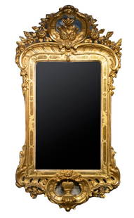 ITALIAN ROCOCO GOLD LEAF MIRROR: Circa 1800 Giltwood Mirror, having a carved openwork frame containing acanthus leaf, urn, floral and scrolled motifs, with wooden back, replaced glass. OS: 59 x 31 1/2 in. (149.9 x 80 cm.)