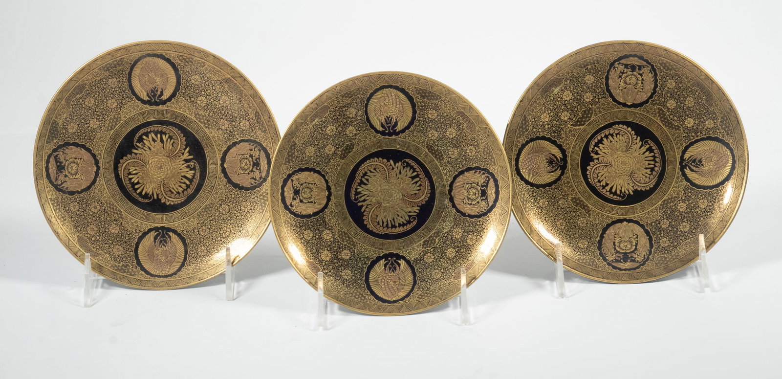 (3) KINKOZAN SATSUMA PLATES: Meiji Period Japanese Porcelain Plates, with intricate gilded bird and floral decoration on a black ground, gold-painted Kinkozan mark and impressed seal mark on base. Each: 6 1/2 x 6 1/2 in. (16.5 x 