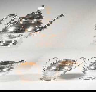 (3) PIECE KALO STERLING TEA SET, HAND WROUGHT: Comprising a teapot, creamer, and sugar bowl, each of hammered surface with hand-wrought body, applied monogram "A", and ivory insulators on the teapot handle and lid. Marked “STERLING / HAND WR