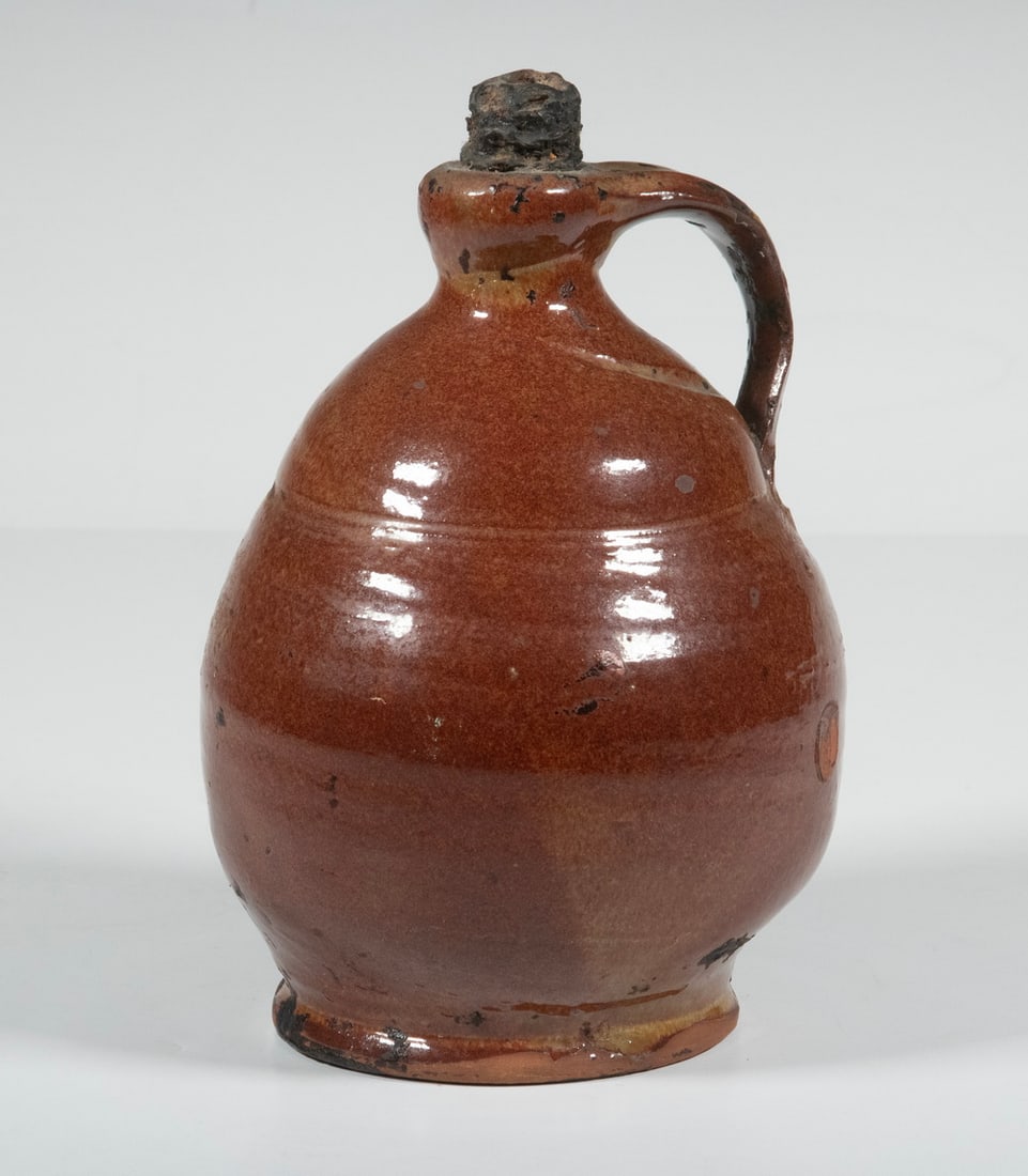 MAINE REDWARE JUG, ATTRIBUTED TO NORCROSS: MAINE REDWARE JUG, ATTRIBUTED TO NORCROSS Mid-19th c. Copper Glazed Jug, attributed to Matthias Norcross of Farmington, ME, with a tooled indentation below the shoulder, applied handle. From the estat