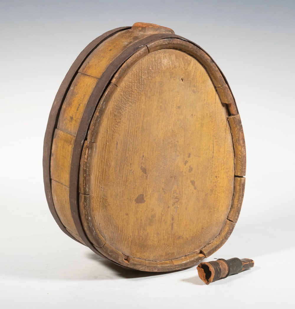 LATE REVOLUTIONARY WAR STANDING CANTEEN: Oak Teardrop Canteen, retaining the original iron bands, raised port top center with remnants of original stopper. Found in Maine. 11 x 9 x 4 1/2 in. (27.9 x 22.9 x 11.4 cm.)