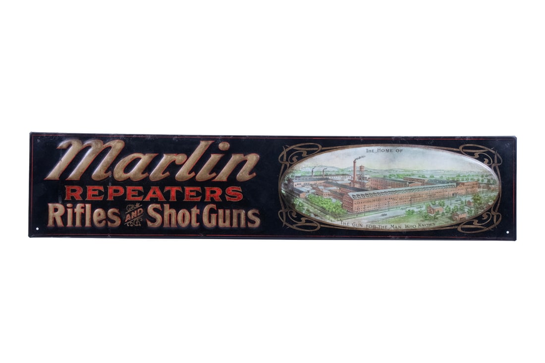 VINTAGE MARLIN FIREARMS SHOP ADVERTISEMENT: An offering of a vintage stamped and painted metal advertisement for Marlin Firearms. The sign features the company's name alongside an oval inset scene depicting the original Marlin factory at its or