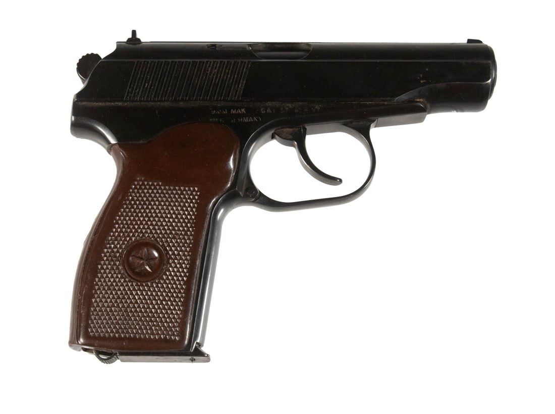E. GERMAN MAKAROV PISTOL, 9mm MAK: An offering of the standard sidearm for the Warsaw Pact as made in the DDR. The pistol features a deep blued finish throughout with fixed sights, a safety/decocker mounted to the slide, and aftermarke