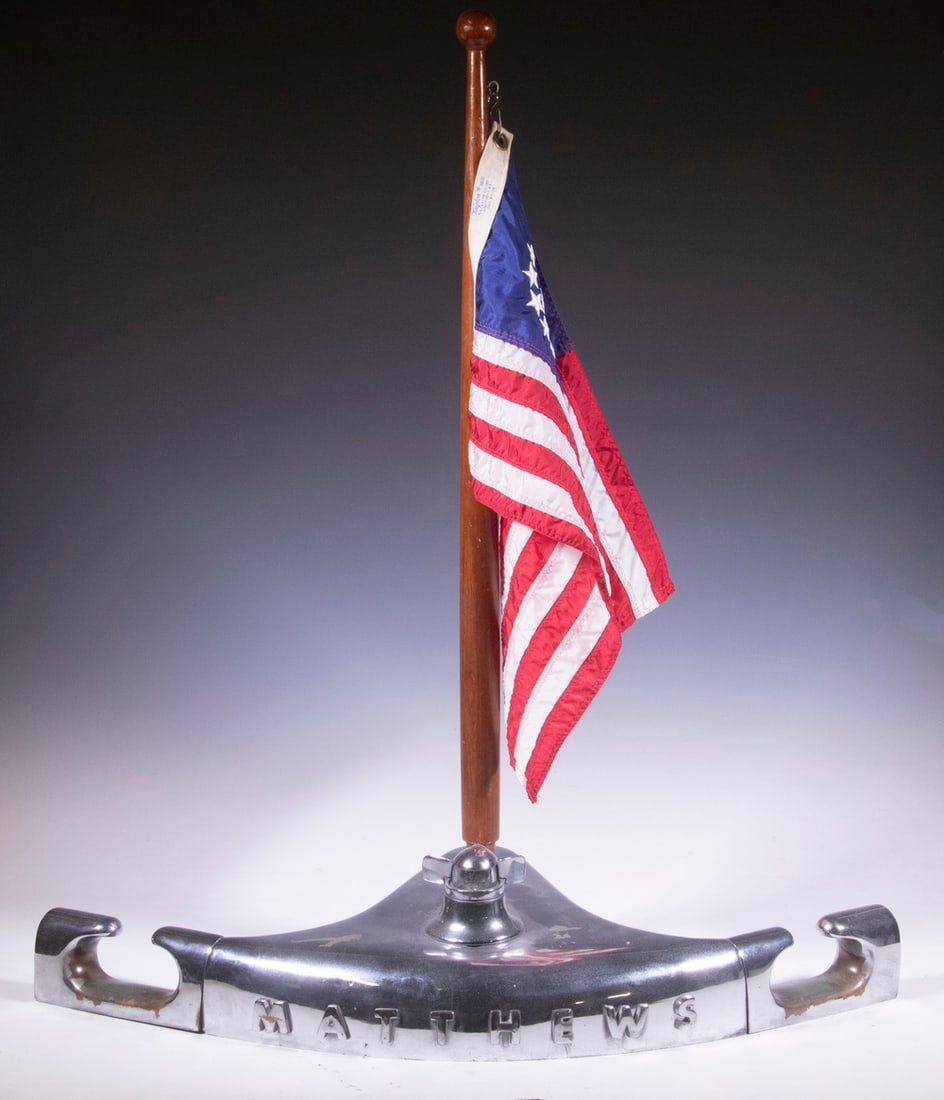 1930'S MATTHEWS CABIN CRUISER BOAT PROW W/ FLAG STANCHION: Rare Vintage Art Deco Boat Prow in heavy chromed bronze, with built-in bow light, "Matthews" spelled out on front, open cleats at each end, mahogany flag stanchion. Some nautical wear.The Matthews Boa