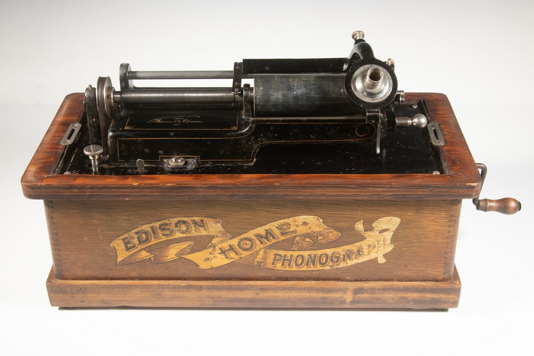 EDISON HOME MODEL PHONOGRAPH: Cylinder player, in oak case, last patent date 1903, s/n H-121313, includes crank, lacking horn. Cased: 13 x 17 1/2 x 8 1/2 in. (33 x 44.5 x 21.6 cm.)