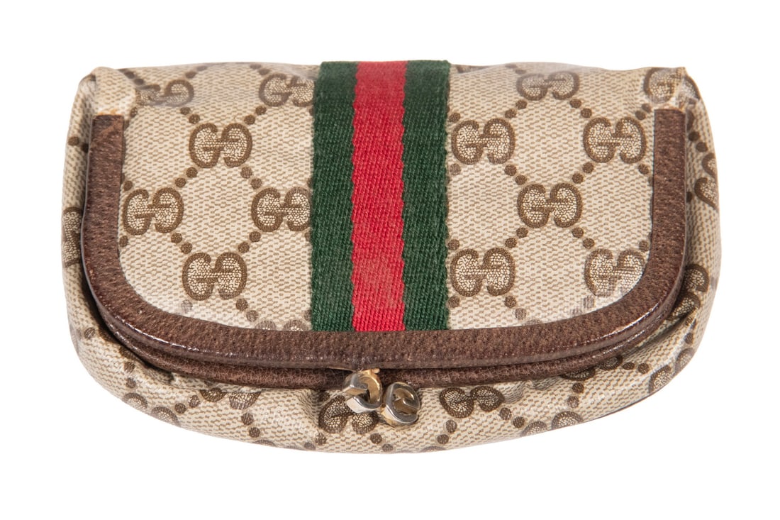 VINTAGE GUCCI ACCESSORY COLLECTION MONOGRAM PVC MAKEUP POUCH: A vintage Gucci cosmetic pouch crafted in coated canvas with all-over GG monogram, accented by the iconic green and red web stripe. Features a hinged opening with integrated mirror and metal GG hardwa