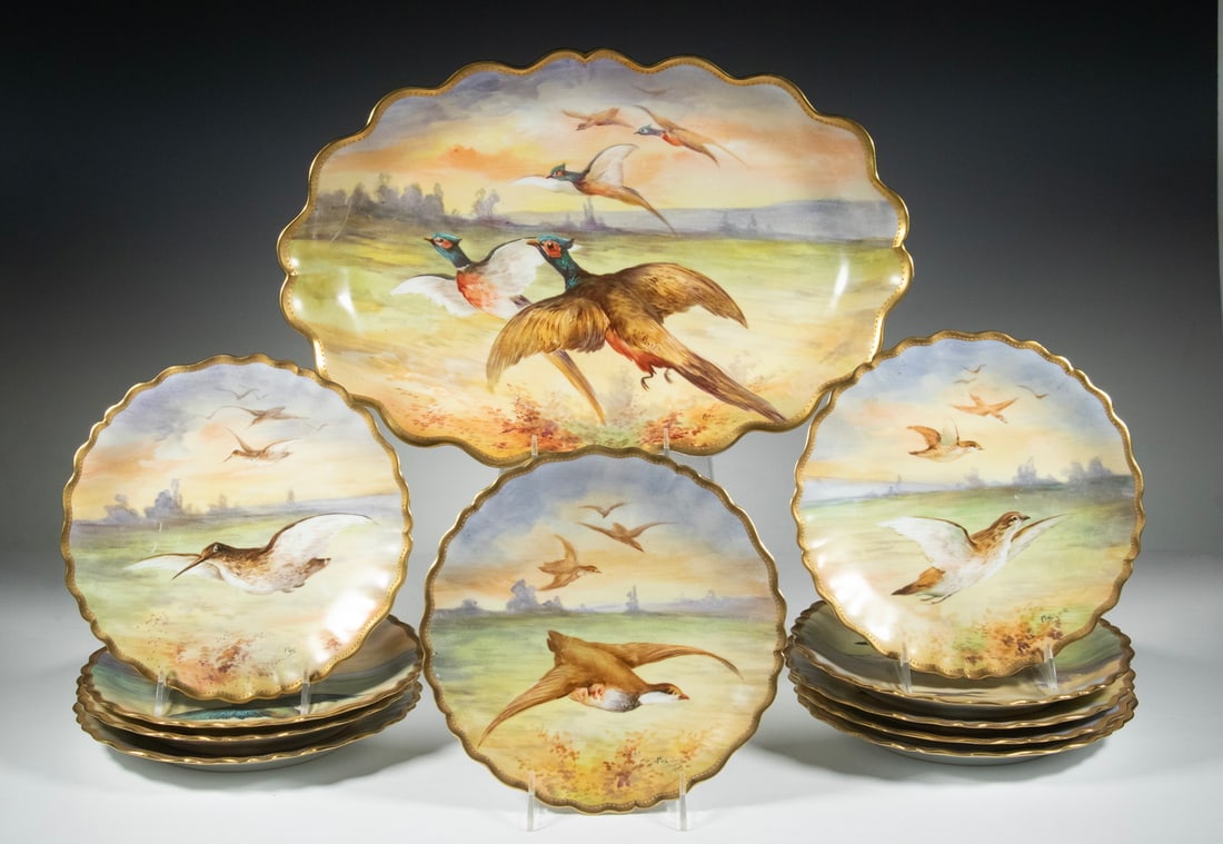 (11) FRANCE LIMOGES GAME BIRD PLATES, SIGNED: A fine set of (11) hand-painted porcelain plates featuring richly detailed scenes of game birds in flight. Each plate is trimmed with a gilt rim and signed on the front. The set includes (10) dinner p