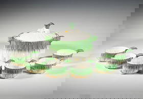 (7) GEORGES BRIARD “L’OIGNON” ONION-FORM COVERED TUREEN AND SIX HANDLED BOWLS: A whimsical majolica-style ceramic tureen with lid and six handled bowls, each molded and painted in the form of scallion bulbs with green and white glaze and yellow highlights. Signed and designed by