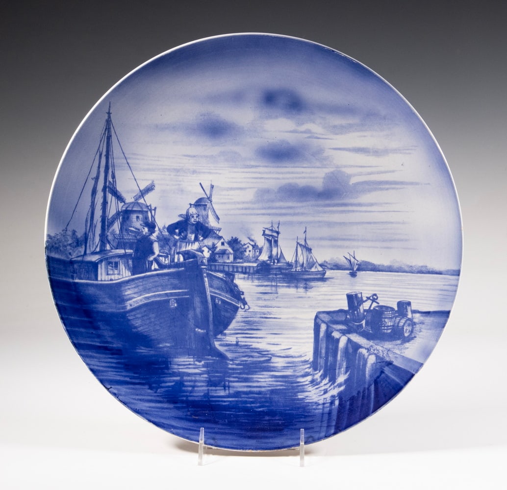 VILLEROY & BOCH DELFT STYLE CHARGER: Early 20th c. Ceramic Wall Plate, by Villeroy & Boch, Mettlach, Germany, decorated with a blue and white Dutch harbor scene, with painted decoration number 2070 and impressed K0B on the base. 15 1/2 x