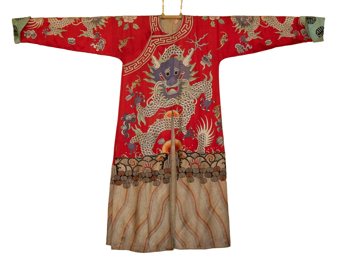 CHINESE EMBROIDERED SILK DRAGON ROBE: Vintage Red Silk Robe, embroidered with polychrome threads and gold metallic trim depicting four five-toed dragons surrounded by bats, flowers, and clouds, above scrolling waves, with asymmetrical fro