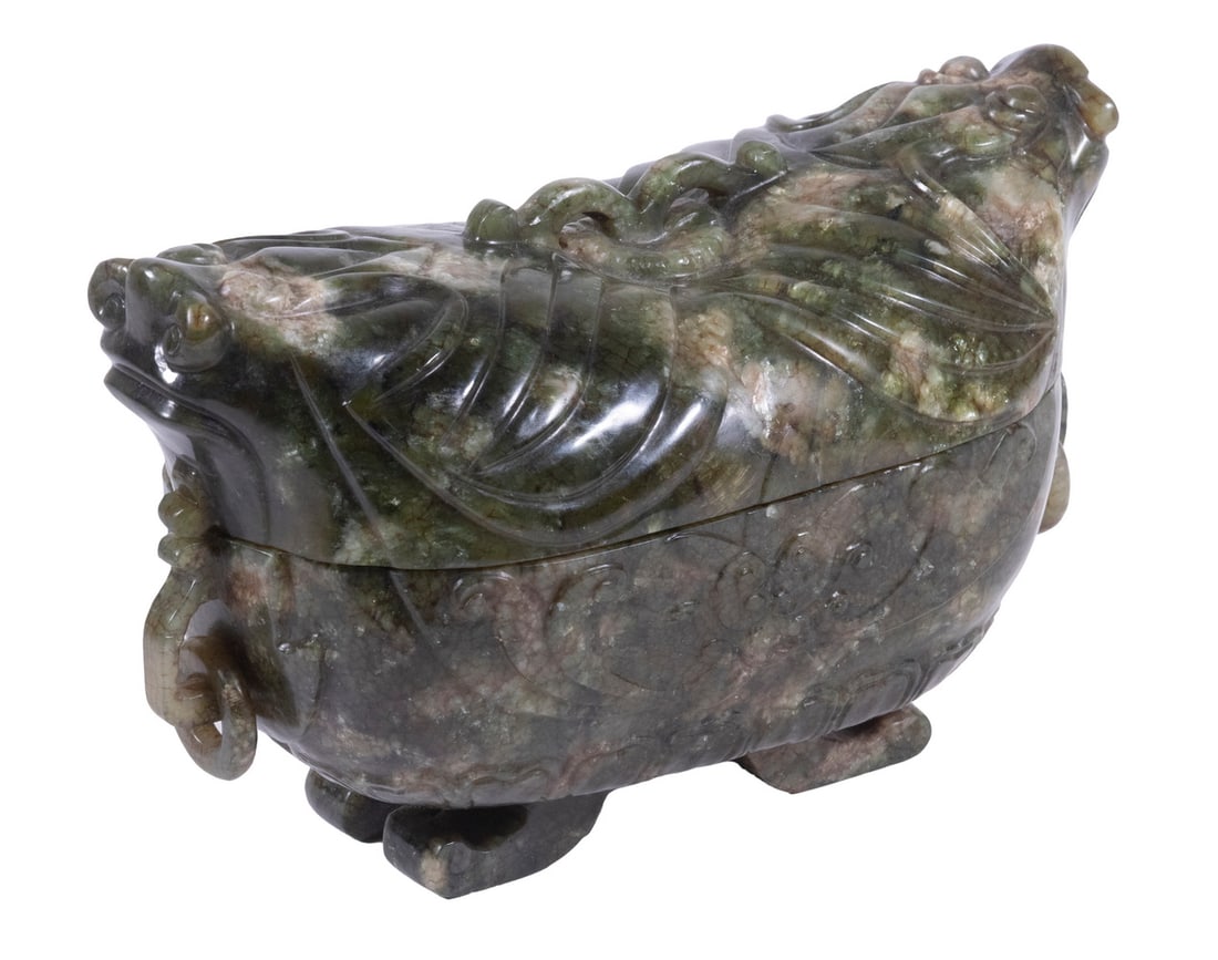 CHINESE JADE COVERED FOOTED BOWL: Variegated grey/green, Archaic Form, with Tao-tie dragon heads at ends, double bow arched knop on top, trapped rings in shaped side lugs, animal form legs, relief decoration to the body. 5 x 8 x 4 in.