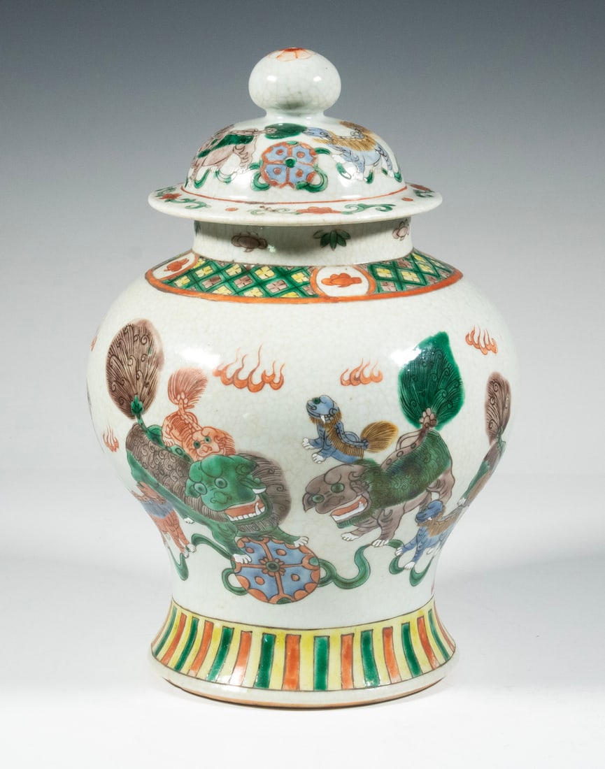 CHINESE FAMILLE VERTE "LION" LIDDED JAR: Globular body with domed lid, painted in overglaze famille verte enamels with Buddhist lions, flaming pearls and cloud motifs. Size: 12 x 8 in. (30.5 x 20.3 cm.)