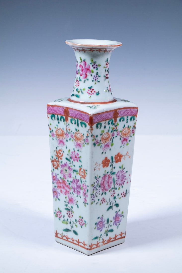 CHINESE EXPORT FAMILLE ROSE SQUARE VASE, LATE QING: The square-form porcelain vase decorated in vibrant famille rose enamels with floral scrolls and stylized borders in shades of pink, orange, and turquoise. The flared neck painted with blooming peonie