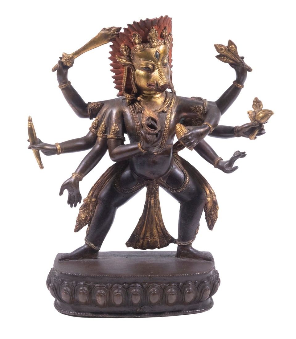 NEPALESE GILT AND PAINTED BRONZE VARAHA FIGURE: Varaha, avatar of the Hindu God Vishnu, in the form of a Wild boar, having eight arms, each wielding a specific weapon, mounted on lotus plinth, partly gilt with red painted feather crown. 11 x 9 x 3