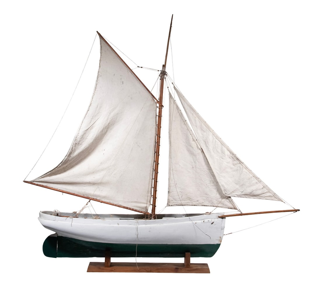 LARGE 1920 VINTAGE DOWNEAST POND MODEL: Weighted Wooden White Hull Model of a Coastal Schooner, with grey deck, mahogany mast and spars, cotton sails, working rudder, on early stand. Size: 45 x 50 x 8 in. (114.3 x 127 x 20.3 cm.)