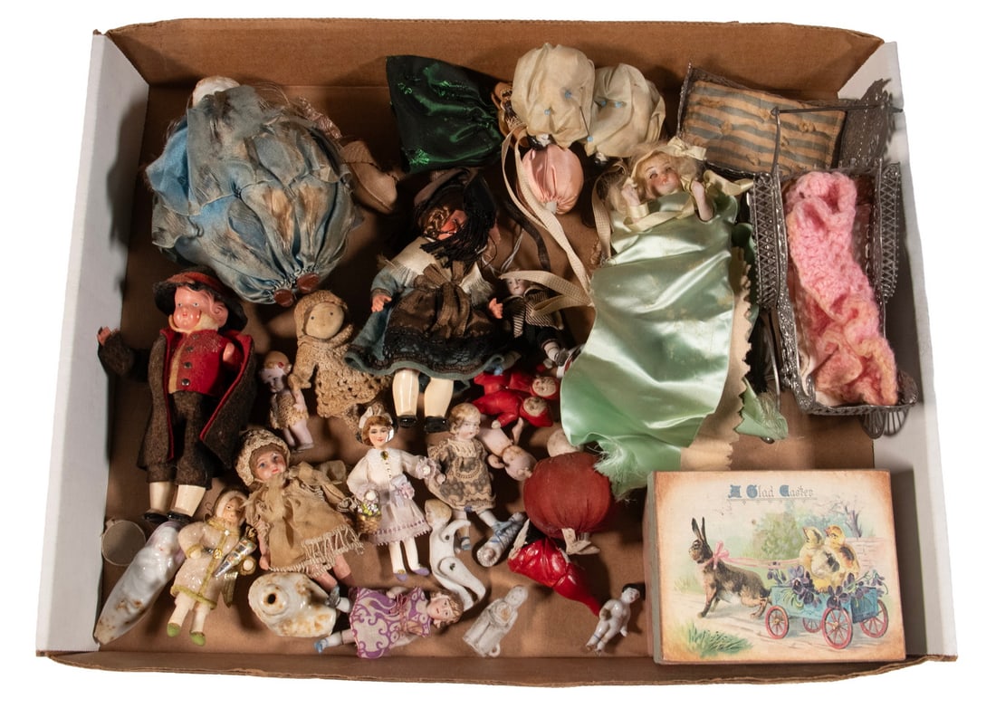 TRAY LOT OF TINY DOLLS, MOSTLY BISQUE: Plus accessories that include a white meta baby carriage and cradle. OS: 5 3/4 x 4 x 2 3/4 in. (14.6 x 10.2 x 7 cm.)