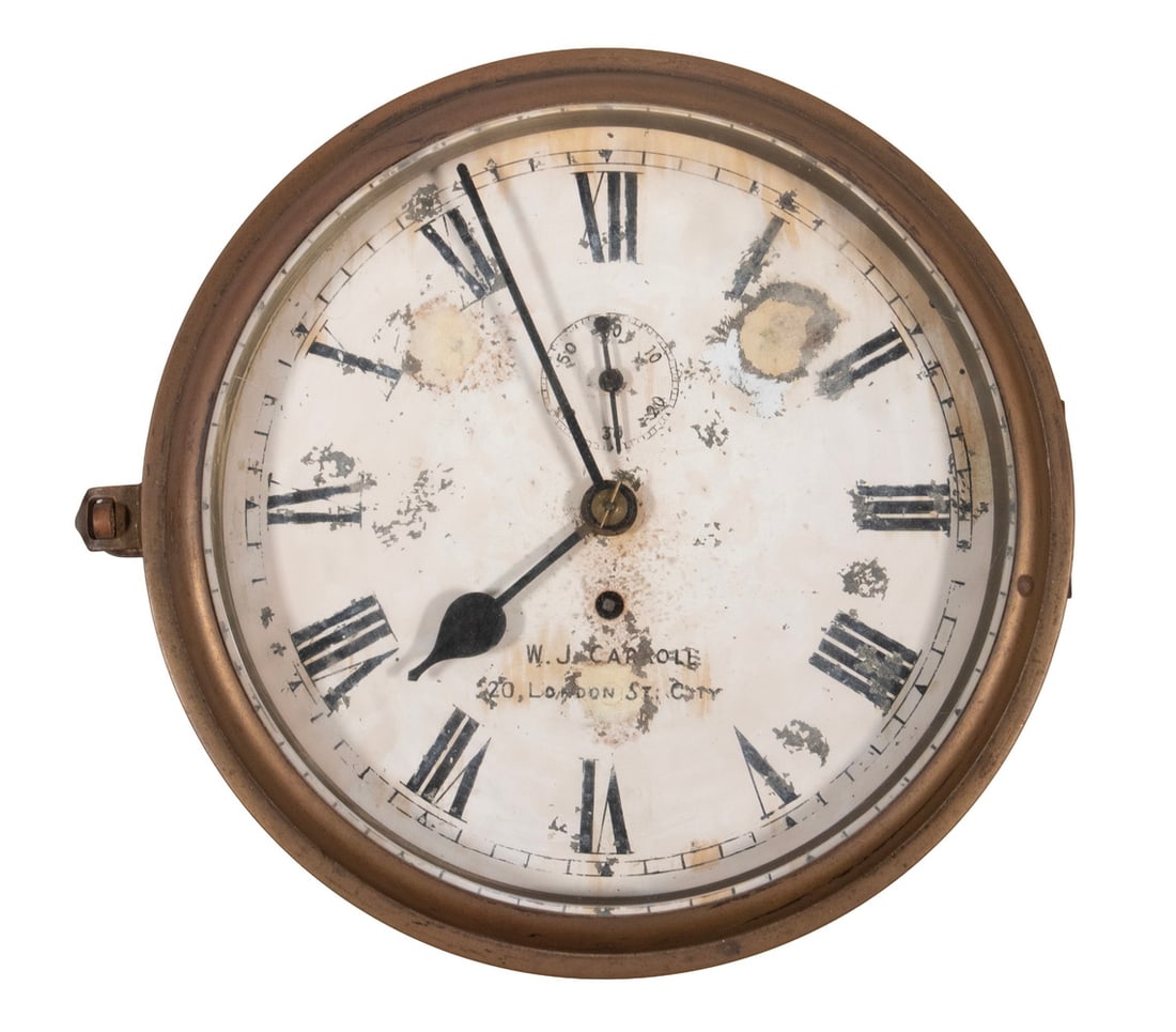 BRASS CASED FUSEE SHIP'S CLOCK MARKED W.J. CARROLL: Late 19th - Early 20th c. English Wall Clock, with brass case and hinged bezel, the enameled metal face marked "W.J. Carroll, 20, London St., City" (a retailer and watch & chronometer makers to the Ad