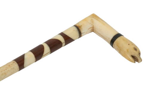 SAILOR-MADE WHALEBONE FIGURAL WALKING STICK: 19th c. Finely Crafted Cane, in carved whalebone, with eagle head form top, baleen spacer, and rosewood decorative inlay, tapered shaft. Length: 32 1/2 in. (82.6 cm.)