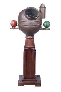 19TH C. EMPTY SHIP'S BINNACLE: Brass Binnacle on mahogany base, retaining the original oil lantern and iron degaussing sphere, lacking compass. Cracked glass, dented rim. 49 x 26 x 15 in. (124.5 x 66 x 38.1 cm.)