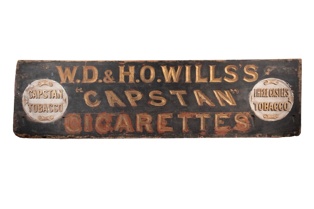 19TH C. BRITISH TOBACCO SELLER'S SIGN, WILLS'S CIGARETTES: Large black painted and gilt carved pine sign "W.D. & H.O. Wills's 'Capstan Cigarettes', with gilt white discs that read "Capstan Tobacco" and "Three Castles Tobacco".W.D. & H.O. Wills was founded by 
