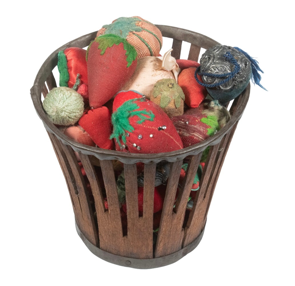 (51) VINTAGE PIN CUSHIONS IN BASKET: Collection of Late 19th - 20th c. Strawberry and Tomato Form Pin Cushions, in various sizes and fabrics, including: (50) Strawberry; and (1) Tomato; in a planter form basket with wooden slat sides and