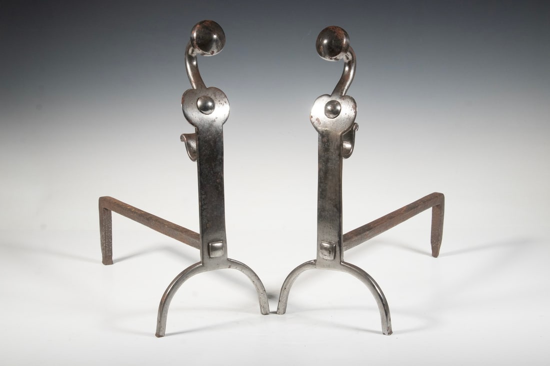 PR EARLY POLISHED IRON ANDIRONS: Pair of English 18th-century. Steel Andirons, with disc design finials and riveted arch form bases, rear log holders. Each: 15 1/2 x 6 1/2 x 14 in. (39.4 x 16.5 x 35.6 cm.)