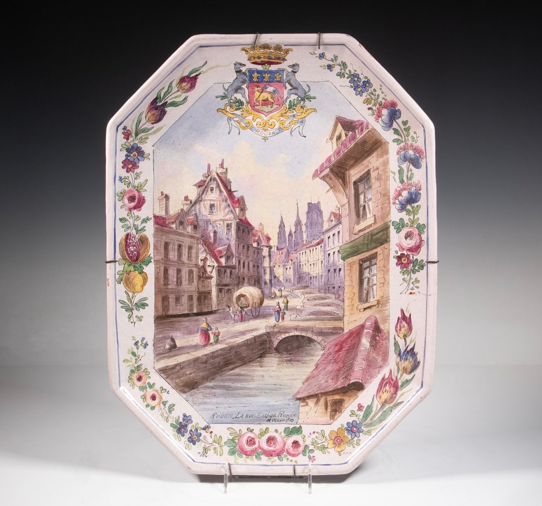 LILLE 1737 FRENCH FAIENCE PLATTER M CLERC: 19th c. Scenic Glazed Earthenware Coffin Shaped Platter, depicting an 18th c. French riverside scene titled "Rouen, La Rue Eau de Robec" and signed "M. Clerc, 1715", to top rim painted with the Rouen
