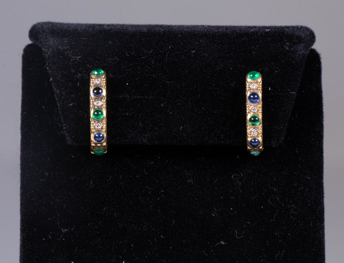 PR ALEX SEPKUS 18K GOLD, EMERALD, SAPPHIRE, AND DIAMOND EARRINGS: A pair of 18K yellow gold earrings by Alex Sepkus, each set with (3) round emeralds, (2) sapphires, and (3) diamonds, arranged in his signature textured gold design. Both earrings are stamped “7
