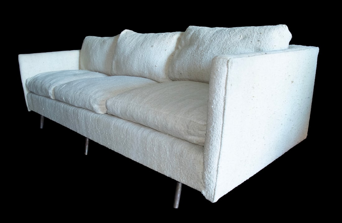KNOLL EIGHT FOOT MODERNIST SOFA: Three- Cushion nubby cream white upholstery with loose pillows, raised on square chrome legs, 17" seat. 27 x 96 x 39 in. (68.6 x 243.8 x 99.1 cm.)
