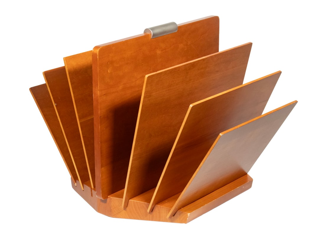 LEVENGER CHERRY WOOD MAGAZINE RACK: Modernist Design Tabletop Literature Holder, by Levenger (Delray Beach, FL), in solid cherry, with six removable side slats, central handle. 14 1/2 x 21 x 16 3/4 in. (36.8 x 53.3 x 42.5 cm.)