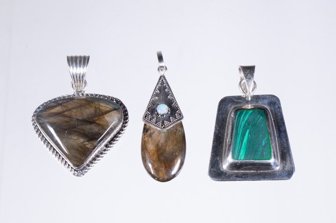 (3) SILVER PENDANTS WITH LABRADORITE AND MALACHITE: A group of (3) sterling silver pendants, including two with polished labradorite cabochons of pear and triangular form, one enhanced with a small round opal accent and granulated silverwork. The third