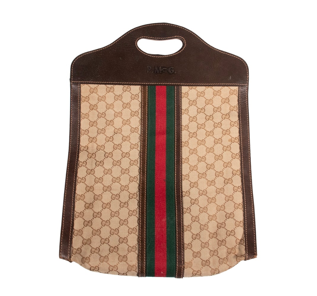VINTAGE GUCCI MONOGRAM CANVAS AND LEATHER TOTE BAG: A vintage Gucci tote bag crafted in signature GG monogram canvas with dark brown leather trim and integrated cut-out handles. Decorated with the iconic green-and-red web stripe running vertically at
