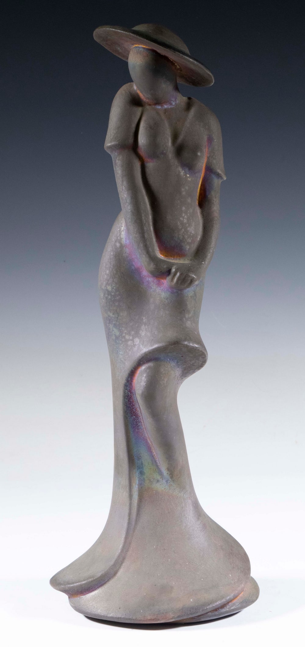 GEORGE TUDZAROV (US, 1944-2000): Standing Fashionable Lady in Wide Brim Hat, raku glazed ceramic sculpture, signed at back base edge "Zaro, 92", also with artist's business card affixed to base.18 1/2 x 6 1/2 x 6 in. (47 x 16.5 x
