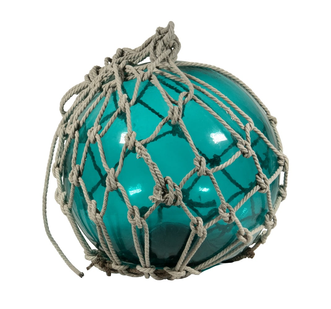 LARGE VINTAGE GLASS FISHING FLOAT: Blown Aqua Glass Float, with heavy net covering, unpolished pontil base.Diam.: 16 in. (40.6 cm.)