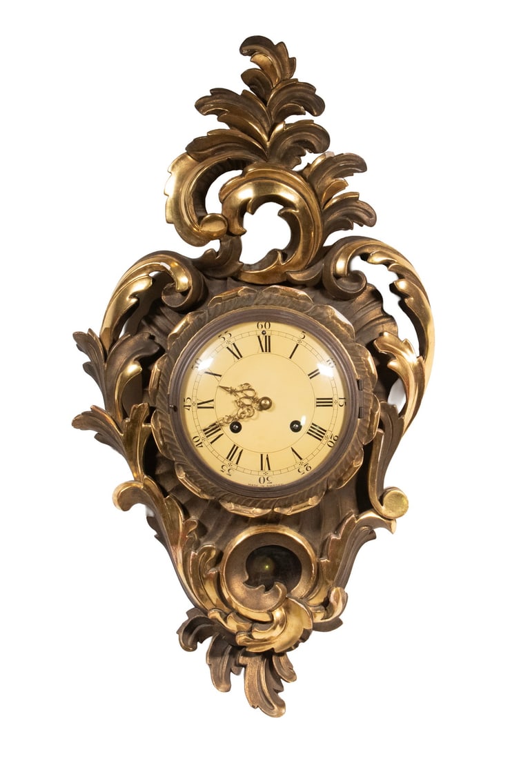 WESTERSTRAND SWEDISH GILTWOOD WALL CLOCK: Vintage Rococo Style Clock, by Westerstrand (Toreboda, Sweden), with pierced and scrolled design gilded case, 8-day time and strike movement (with pendulum and key).OS: 24 1/2 x 13 in. (62.2 x 33 cm.)