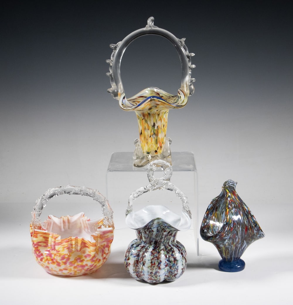 (4) VICTORIAN ERA HAND-BLOWN ART GLASS BASKETS: Four hand-blown art glass baskets in various multicolor spatter and cased-glass designs, each with a shaped rim and applied clear-glass handle or loop finial.LGST: 10 1/2 x 6 x 5 in. (26.7 x 15.2 x