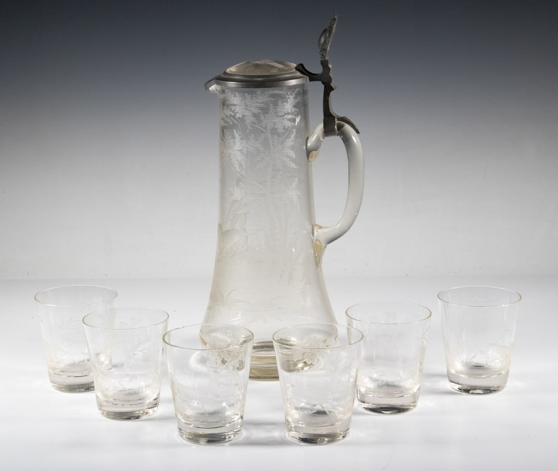 (7PC) BOHEMIAN ETCHED GLASS JUG AND TUMBLERS SET: A seven-piece Bohemian clear glass set comprising a lidded jug and six matching tumblers. The jug is finely wheel-etched with a hunter, dog, and forest landscape; the tumblers each depict two