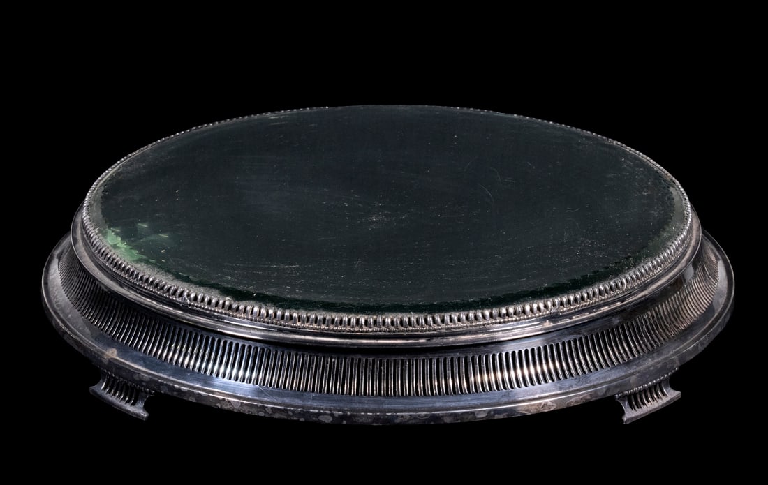 SILVER-PLATED PLATEAU: Circa 1900, round silver-plated mirror top, centerpiece platform. Wheel cut edge around mirror on open reticulated rise with four matching feet, marked Forbes Plate #2871-14. Good condition, minor scr