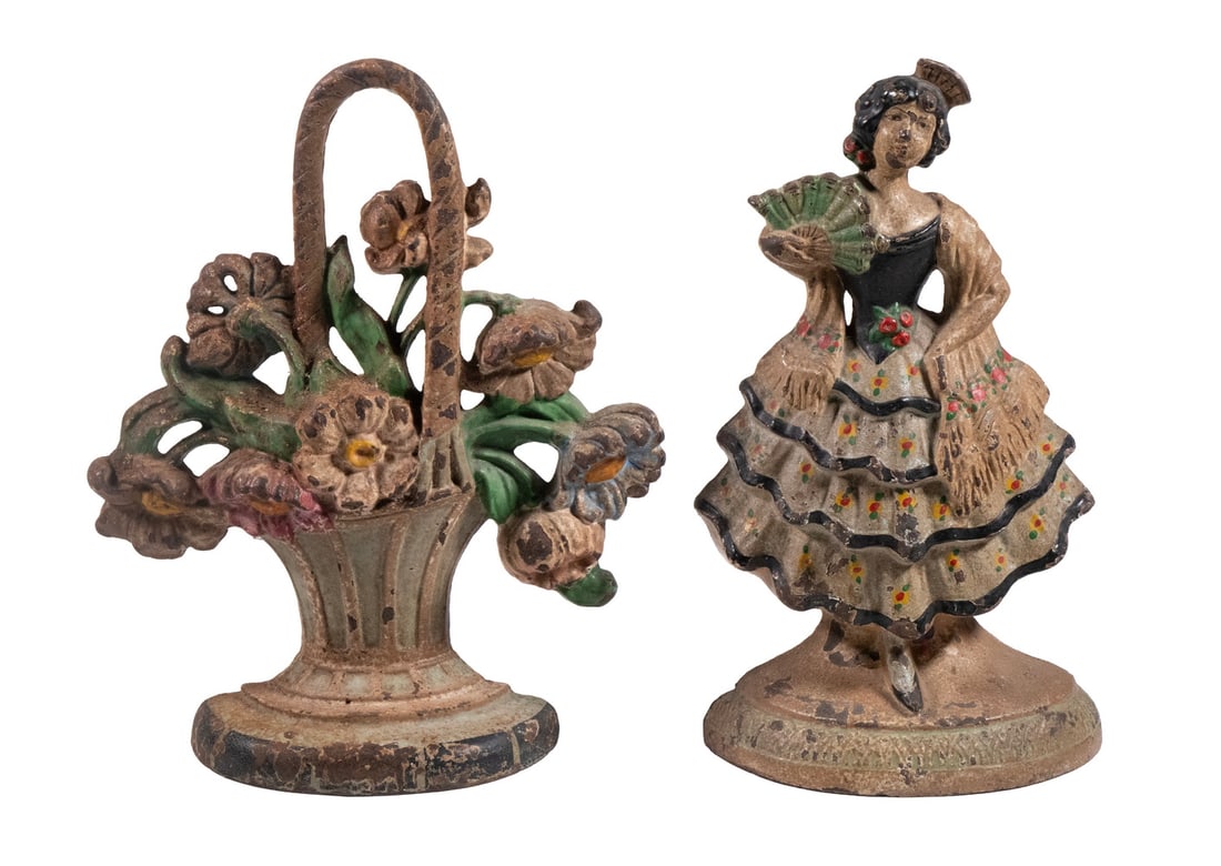 (2) CAST IRON DOORSTOPS: Circa 1920 Painted Cast Iron Spanish Flamenco Dancer and Basket of Flowers.LGST: 9 x 7 1/2 x 2 in. (22.9 x 19.1 x 5.1 cm.), SMST: 9 x 5 x 2 1/2 in. (22.9 x 12.7 x 6.4 cm.)