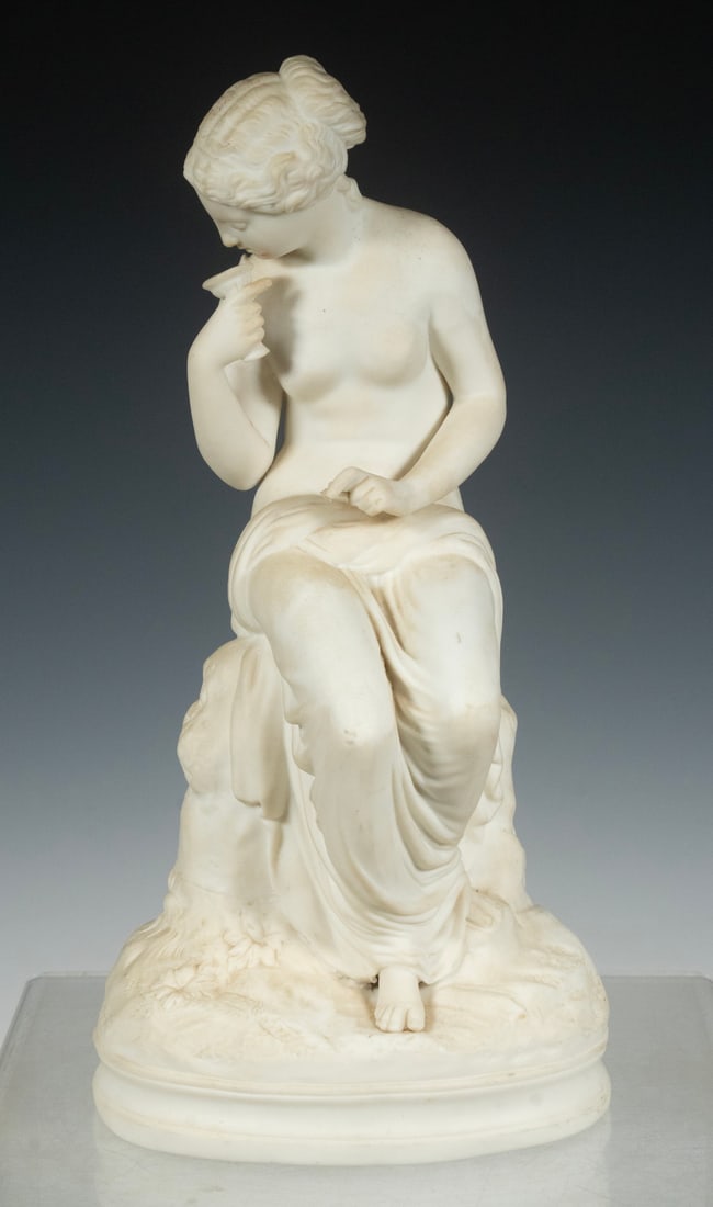 PARIAN PORCELAIN FIGURE OF CLASSICAL WOMAN: Vintage Bisque Sculpture, ca. mid-20th c., depicting a seated Classical female figure, holding a small stemware cup, on an oval base. Finger and shoulder chips.Height: 13 in. (33 cm.)