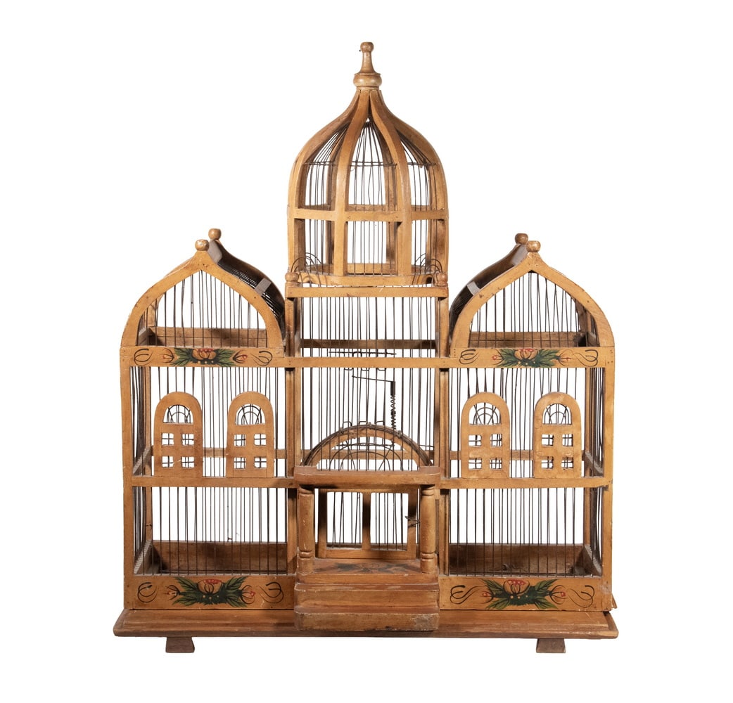 VICTORIAN STYLE WOOD & METAL BIRD CAGE: Ornate Gothic Design Cage, with wooden frame and wire bars, central cupola and domed sides, working front door, painted front accents, set on a separate wooden plank base.33 x 27 x 13 in. (83.8 x