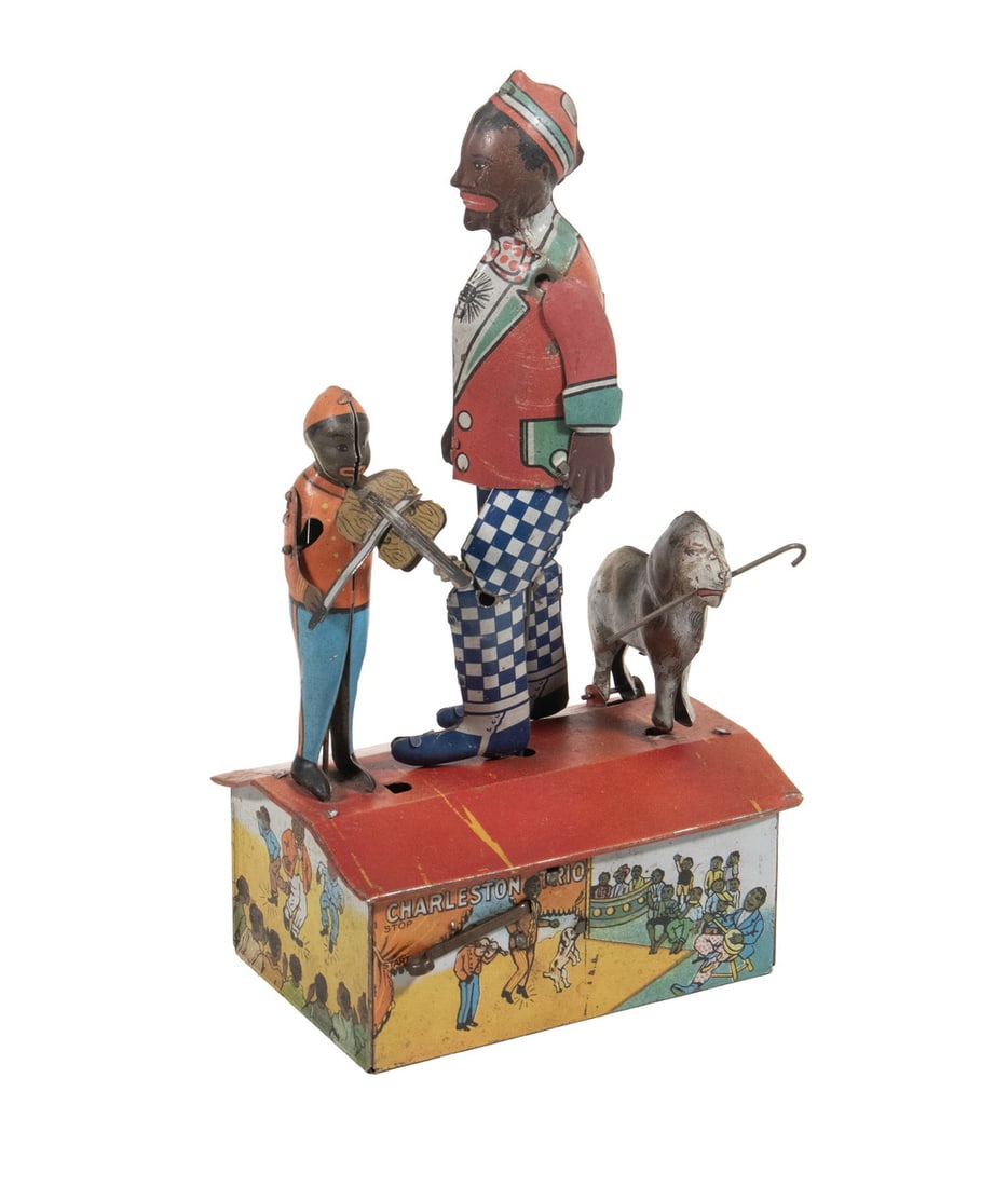 LOUIS MARX & CO. “CHARLESTON TRIO” WIND-UP TIN TOY, C.1921: A lithographed tin wind-up toy by Louis Marx & Co., New York, depicting a trio of performers dancing the Charleston atop a rectangular base, with colorful printed scenes of crowds and musicians. Part