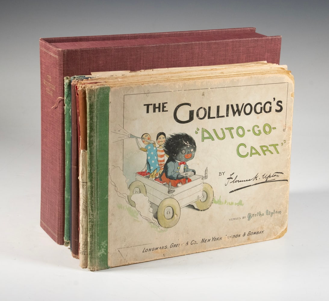 (6) GOLLIWOGG BOOKS, CA 1900, IN CLAMSHELL CASE: Including: "Auto-Go-Cart"; "In the African Jungle"; "At the Sea-Side"; "In War"; "Fox Hunt"; "In Holland", and unidentified fragment. Various conditions.Box Size: 9 3/4 x 12 in. (24.8 x 30.5 cm.),