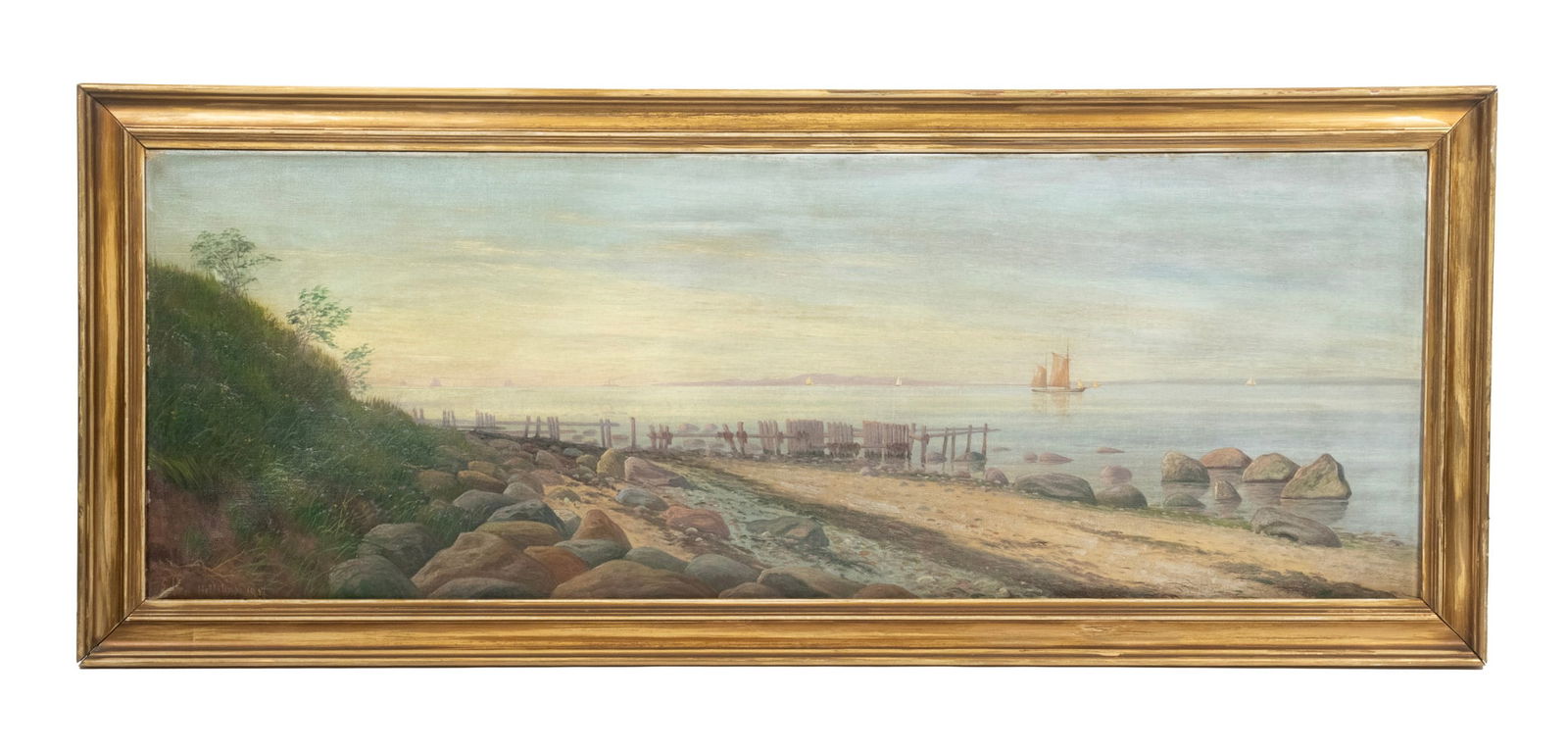 DANISH COASTAL PANORAMIC SEASCAPE: View of a Decaying Pier on a Rocky Beach at Dawn, oil on canvas, illegibly signed lower left (Hellesen?), in gold molded frame. OS: 16 x 39 1/2 in. (40.6 x 100.3 cm.), SS: 12 1/2 x 36 in. (31.8 x 91.4