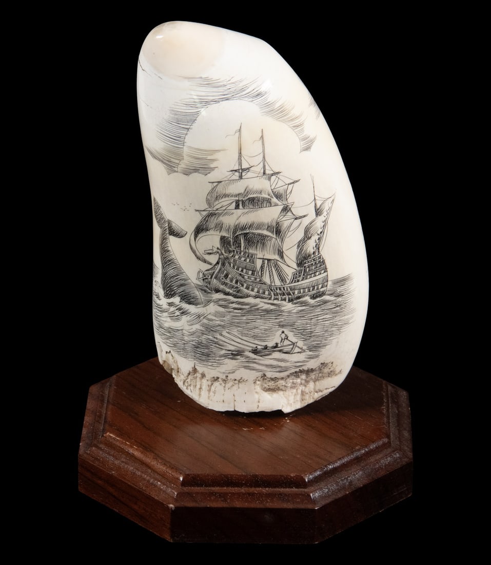 LARGE 2-SIDED SCRIMSHAWN WHALES TOOTH OF WHALERS AT WORK: One side with Ship, Longboat and Sounding Whale, the other with Two Ships, Three Whales and Men in Longboat, signed Kathy, vertical. 17.0 oz, includes stand. Size: 5 3/4 in. (14.6 cm.)