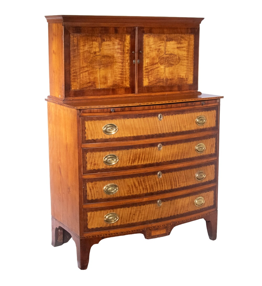 RARE PORTSMOUTH, NH FEDERAL BOWFRONT BUTLER’S SECRETARY CHEST: Unusual Circa 1800 Two-Part Curly Maple, Cherry and Mahogany Inlaid Chest. The upper case having two curly maple inlaid panel doors inlaid with oval paterae and mahogany cross-banding, opening to an