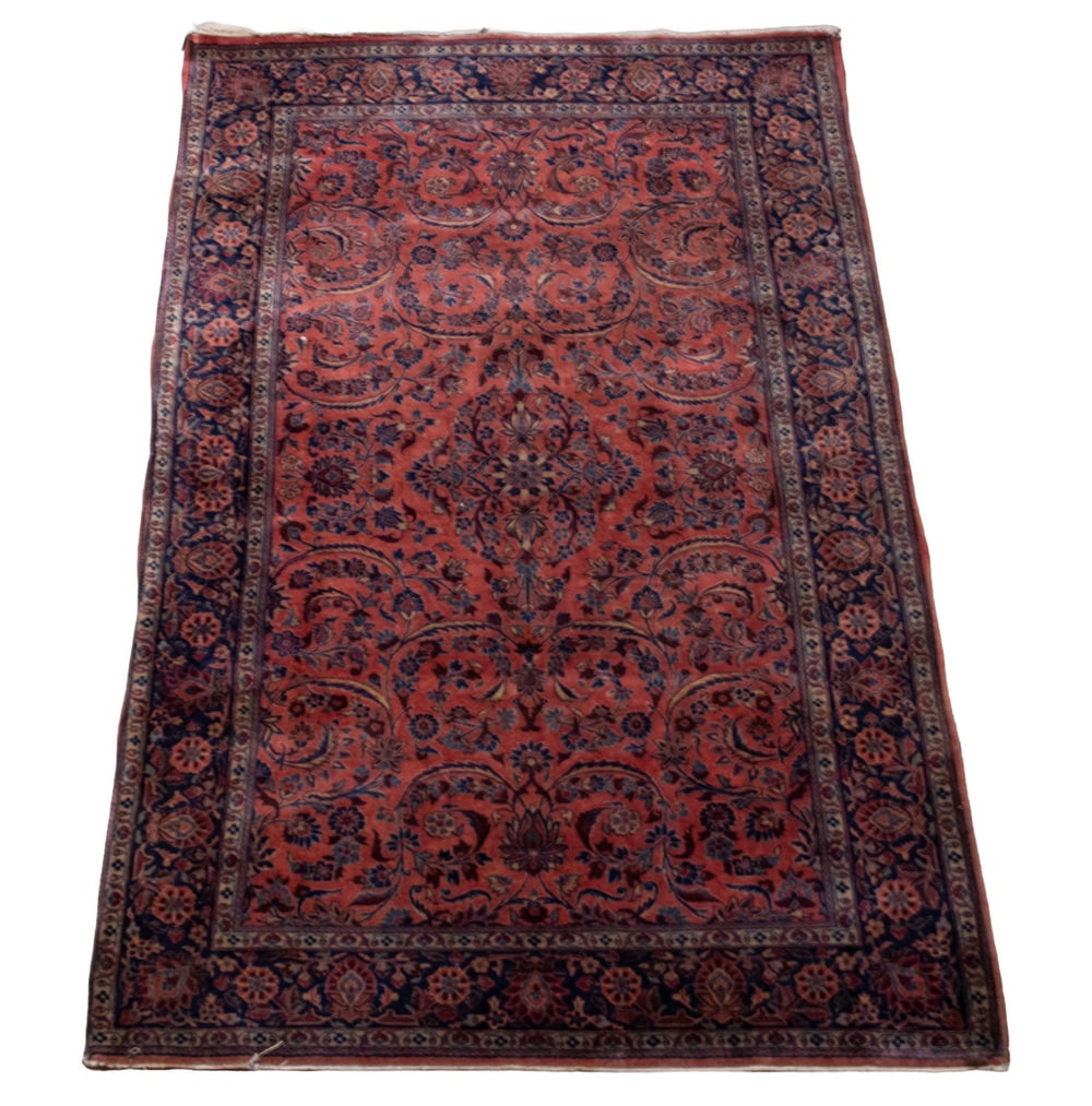 SAROUK RUG (4'4" X 6'7"): Made in West Persia in the first quarter of the 20th Century. Features an overall design of flowering vines, palmettes, and serrated leaves in midnight and sky blue; burgundy, and rose on the wine