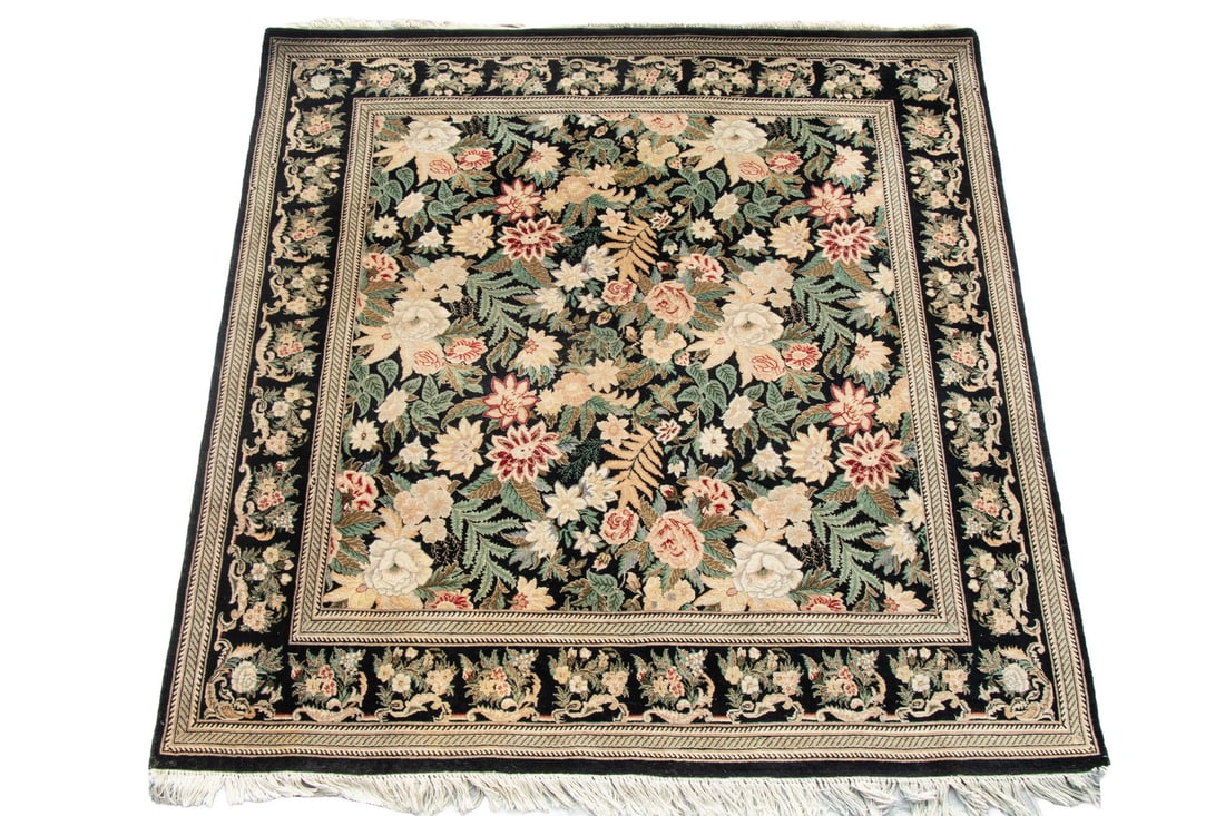 PAKISTANI KASHAN STYLE RUG (6' X 6'2"): Made in the late 20th Century. Features an overall design of a dense field of serrated vines, flowerheads, and palmettes in red, blue-green, gold and ivory on the midnight blue and black field with a