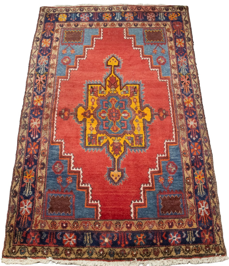 NORTHWEST PERSIAN RUG (4'4" X 6'10"): Made in the mid-20th Century. Features a butterscotch and Persian blue center medallion inset on an open tomato field with Persian blue spandrels and a midnight blue rosette border. Overall good condi
