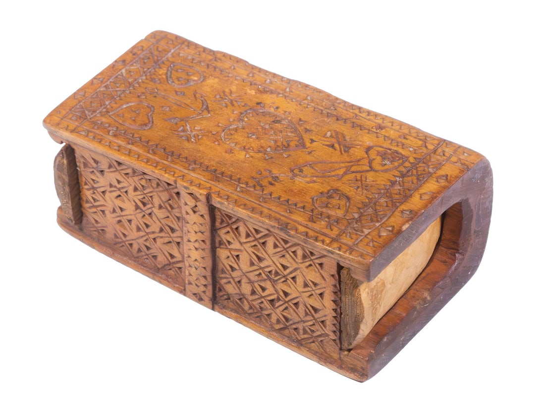 FOLK ART CARVED SPRUCE GUM BOX: 19th c. Book Form Box, hand-carved with geometric motifs, cross on one side, hearts, anchor and peace dove on the other. Replaced lid.Size: 5 1/4 x 2 x 2 3/4 in. (13.3 x 5.1 x 7 cm.)